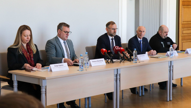 Preses konferences dalībnieki pie galda